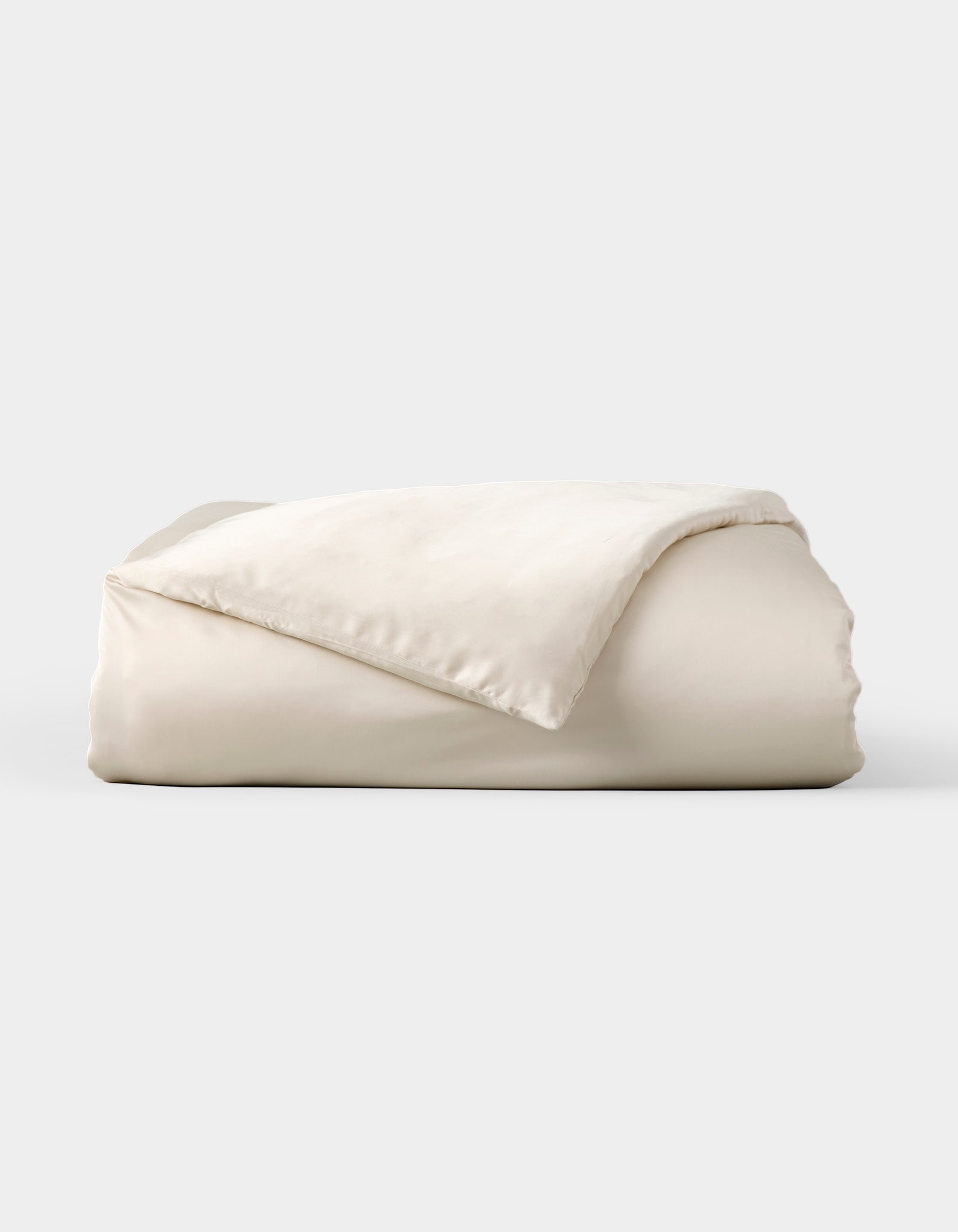 The Cozy Earth Bamboo Duvet Cover, shown neatly folded with one corner flipped to reveal its soft, smooth fabric, is displayed against a plain light gray background.
