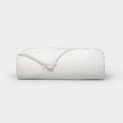 The Cozy Earth Silk Comforter is neatly folded with a corner turned down, showcased against a plain white background.