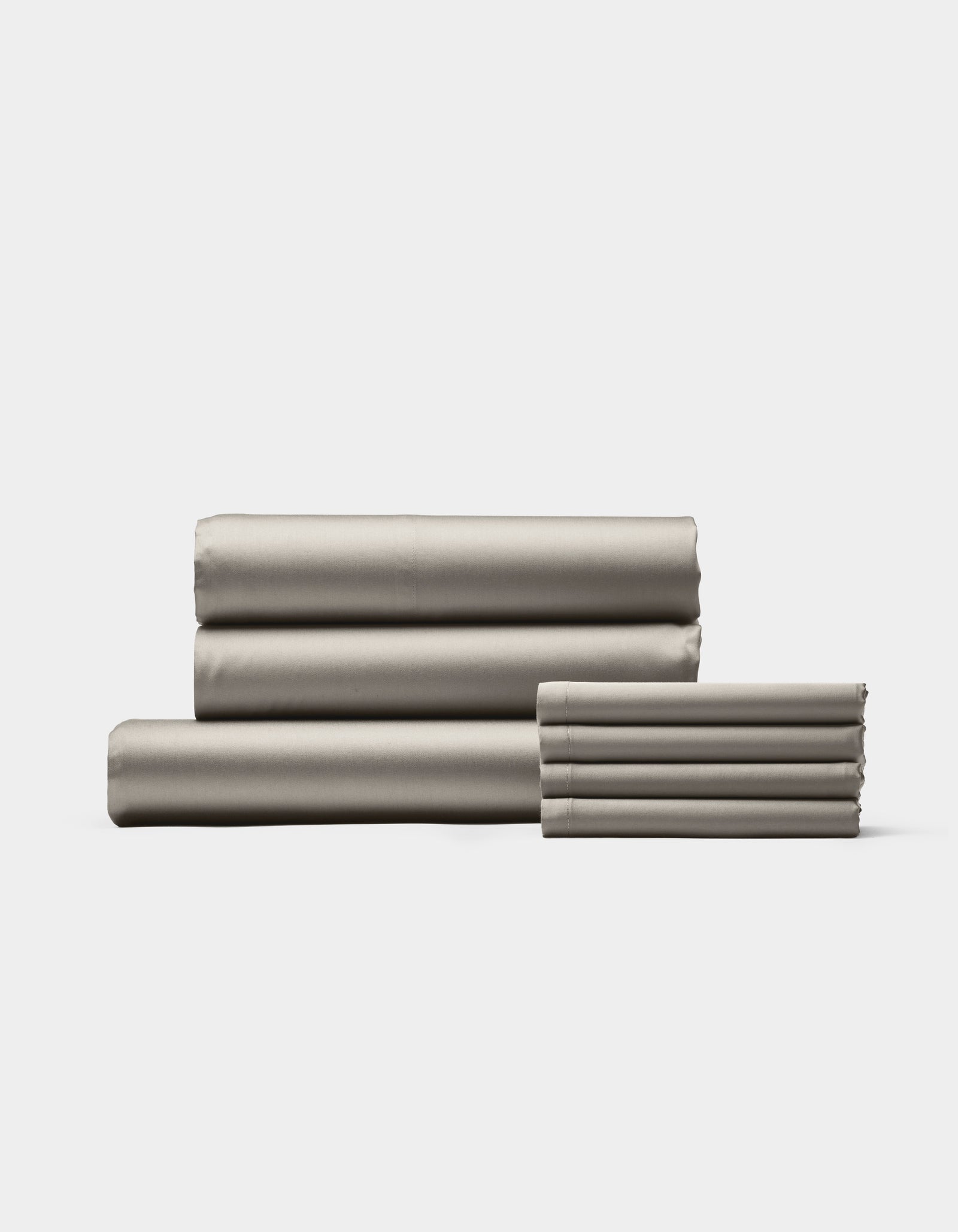 A neatly folded stack of Cozy Earth Bamboo Bedding Core Bundle bed sheets and pillowcases arranged side by side on a plain white background.