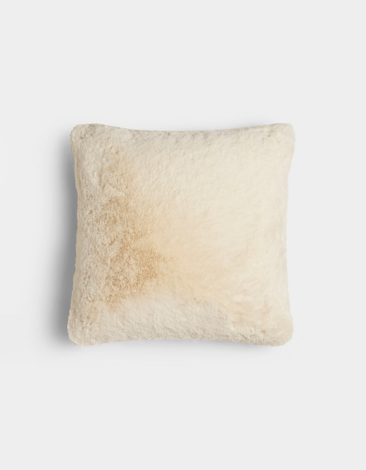 The Cozy Earth Cuddle Pillow is a square, fluffy, cream-colored pillow with a subtle light brown stain on one side, shown against a plain white background.