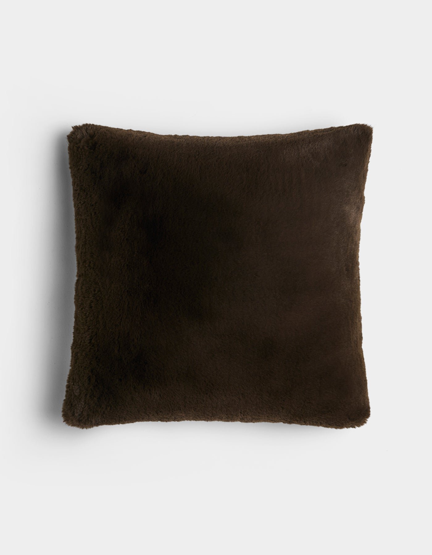 The Cozy Earth Cuddle Pillow is a square, dark brown plush pillow with a soft, fuzzy texture, displayed against a plain white background.
