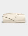The Cozy Earth Bamboo Duvet Cover is shown neatly folded in light beige, with one corner turned back, set against a plain light gray background.|Color:Creme