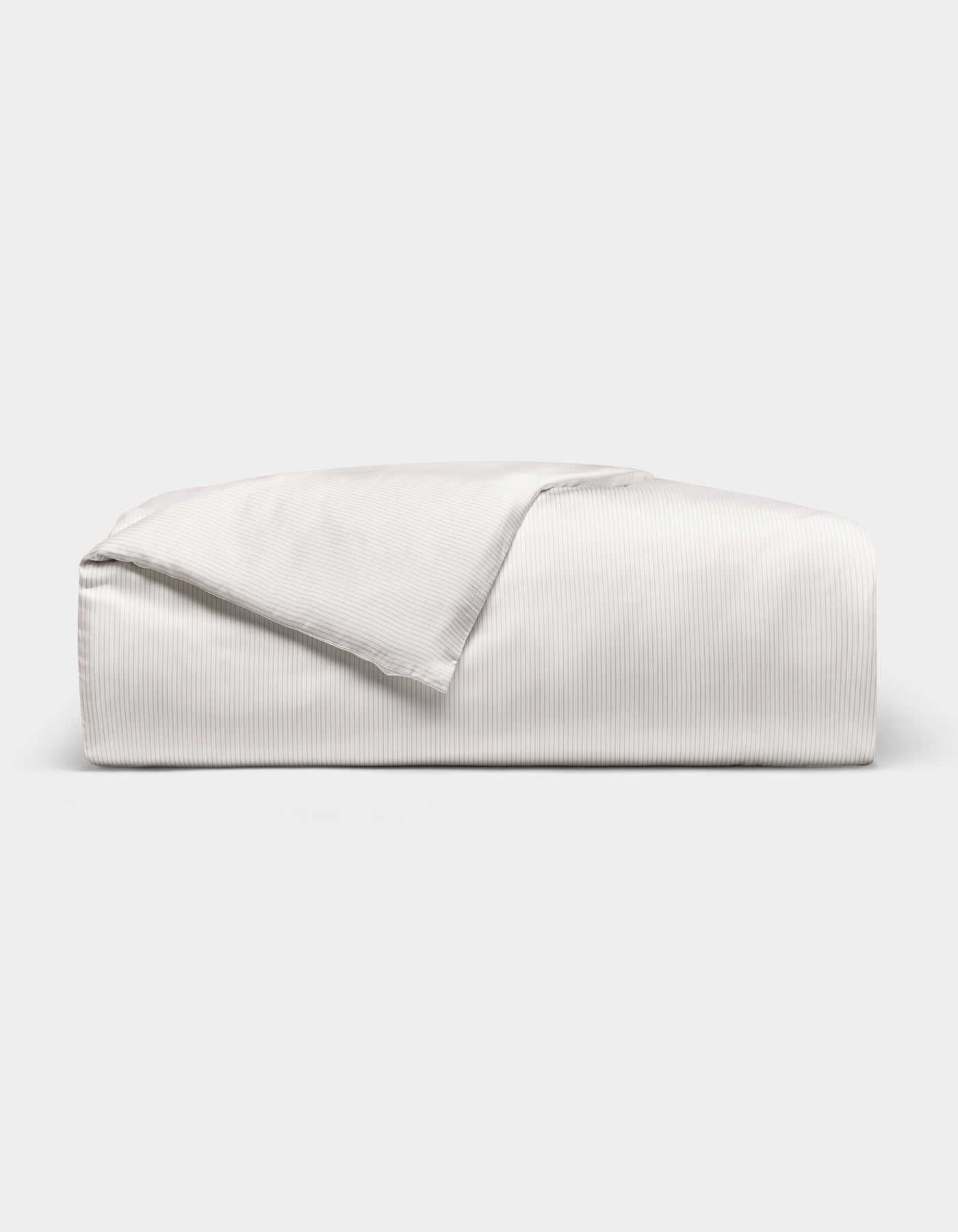 The Cozy Earth Bamboo Duvet Cover, in light gray with subtle vertical stripes, is folded on a white background. A corner is flipped open, showcasing the striped texture on both sides.