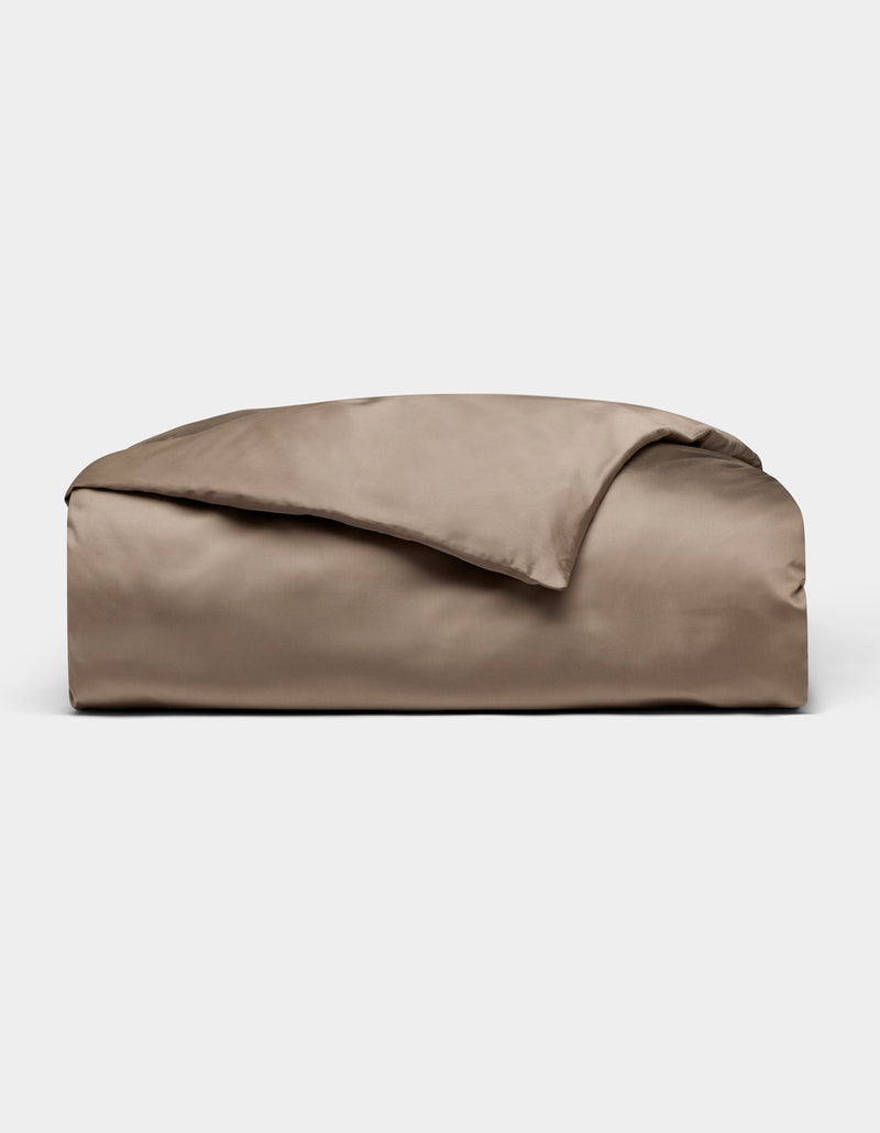 The Cozy Earth Bamboo Duvet Cover in taupe is neatly folded with one corner flipped over, displayed against a plain light grey background.