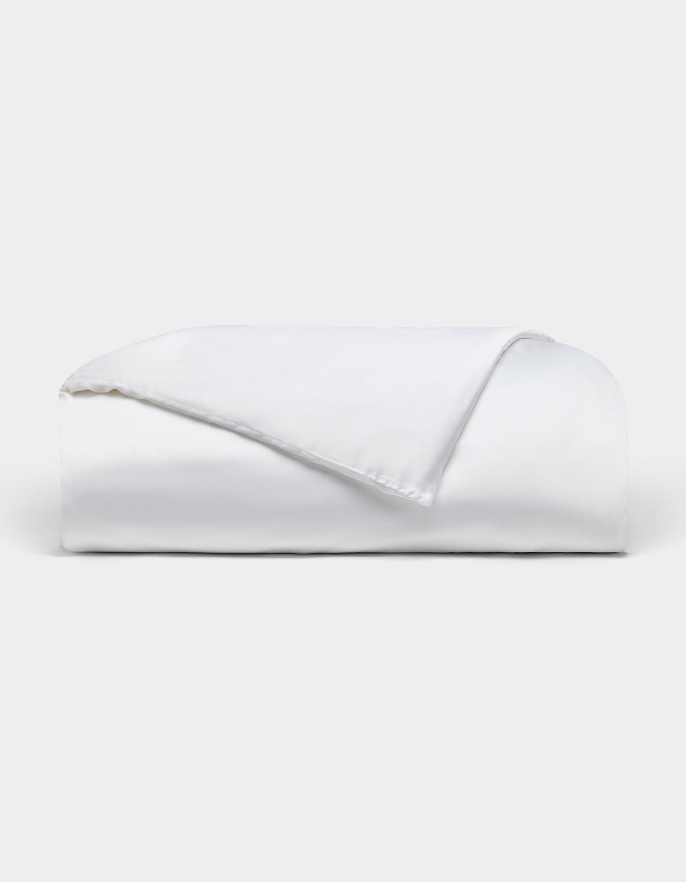 The Bamboo Duvet Cover by Cozy Earth is neatly folded with one corner flipped over, showcased against a plain light background.