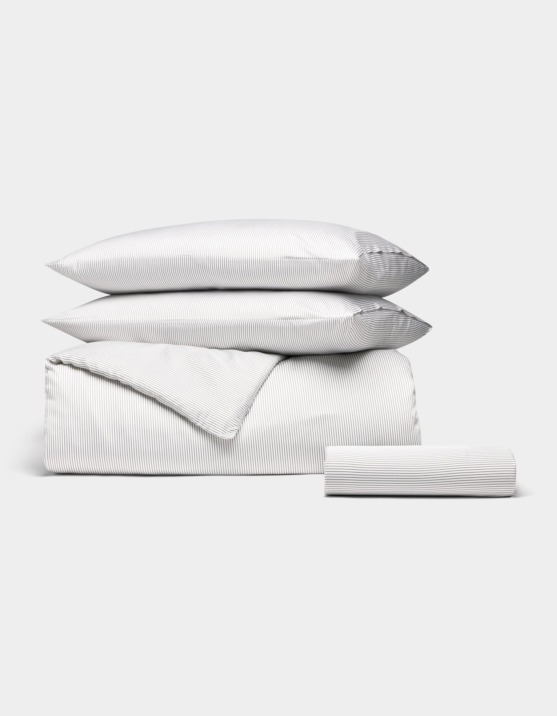 The Bamboo Bedding Essential Bundle by Cozy Earth features a white set with thin gray pinstripes—two pillows, a duvet cover, and a fitted sheet—neatly folded and displayed against a plain white background. |Color:Charcoal Pinstripe