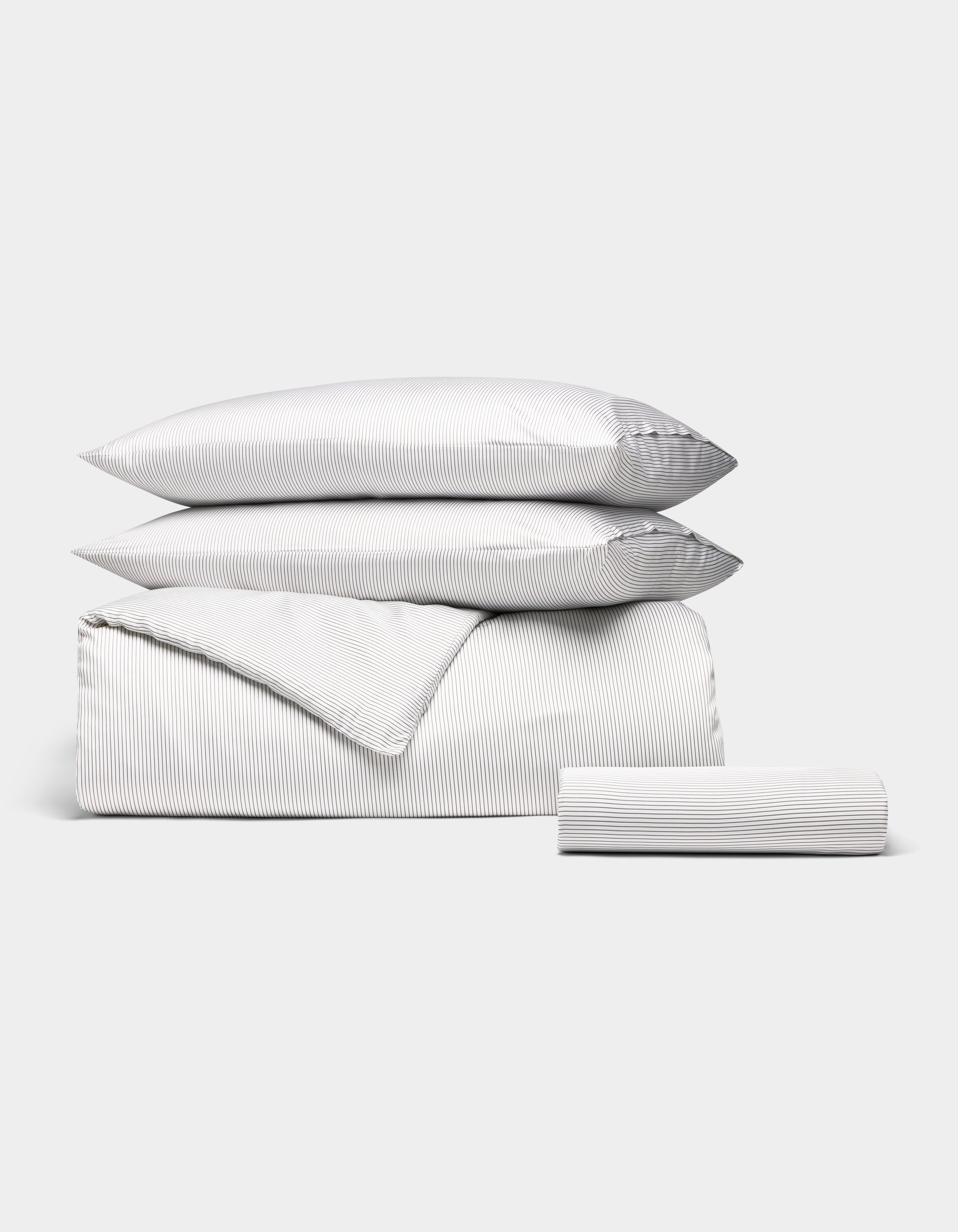 The Bamboo Bedding Essential Bundle by Cozy Earth features a white set with thin gray pinstripes—two pillows, a duvet cover, and a fitted sheet—neatly folded and displayed against a plain white background. |Color:Charcoal Pinstripe