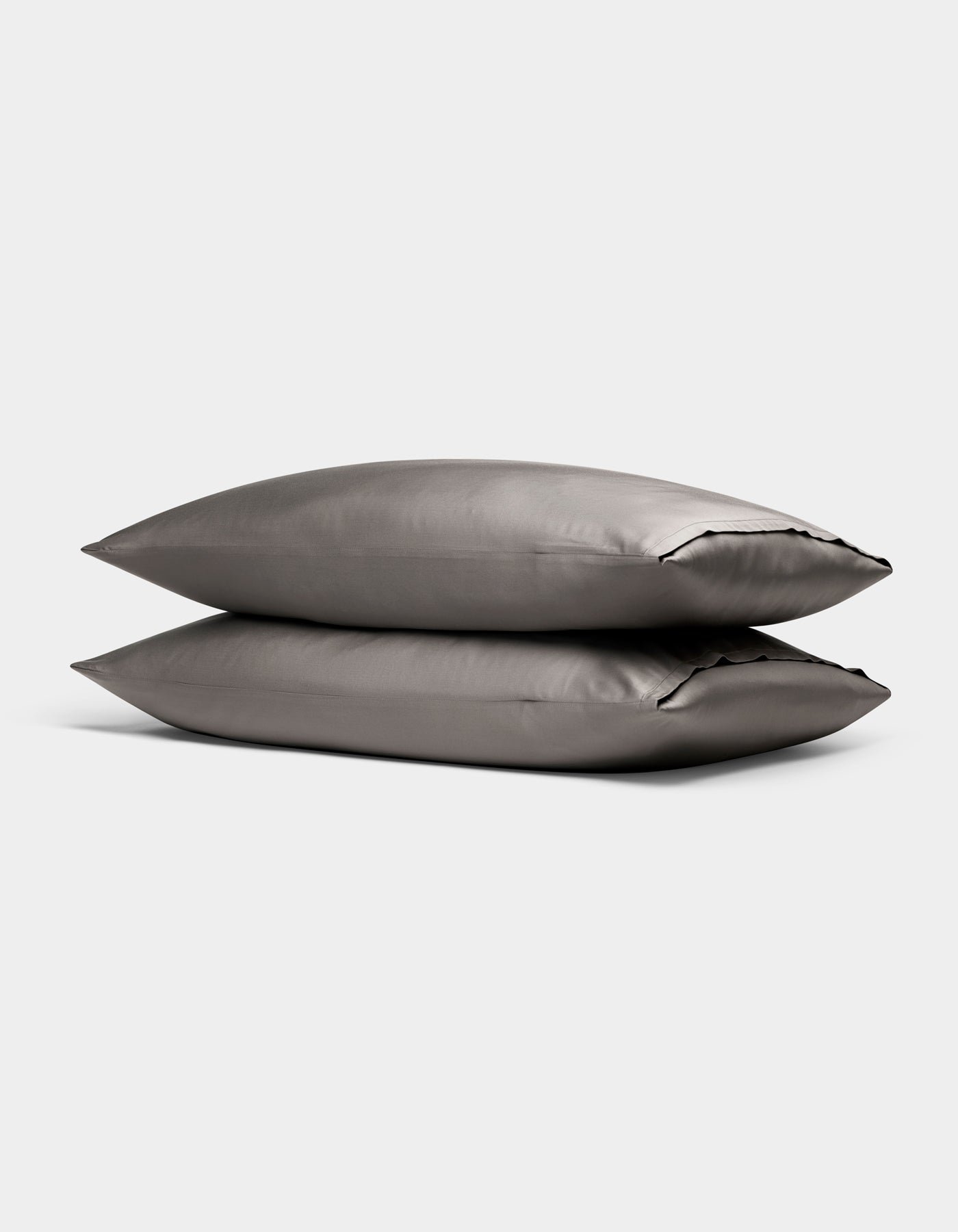 Two Cozy Earth Bamboo Pillowcases in gray are stacked together against a plain light background.|Color:Charcoal