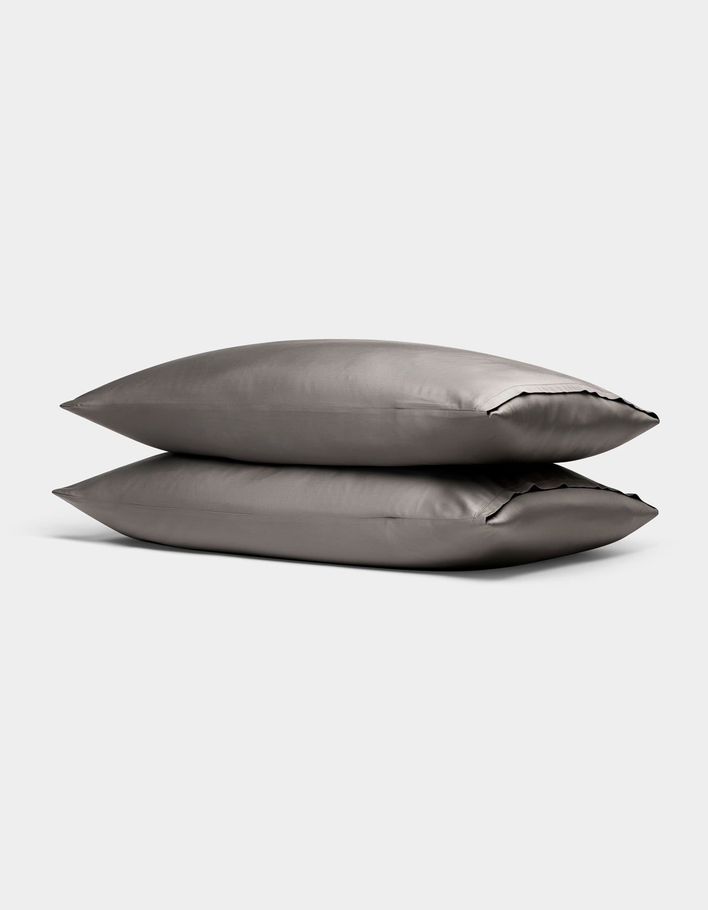Two Cozy Earth Bamboo Pillowcases in gray are stacked together against a plain light background.|Color:Charcoal