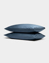 Two Cozy Earth Bamboo Pillowcases in blue are stacked against a plain, light gray background.|Color:Pacific Blue