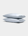 Two Cozy Earth Bamboo Pillowcases in light gray are stacked neatly against a plain, light gray background.|Color:Shore