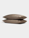 Two Cozy Earth Bamboo Pillowcases in taupe, rectangular and neatly stacked on top of each other, are displayed against a plain light gray background.|Color:Walnut