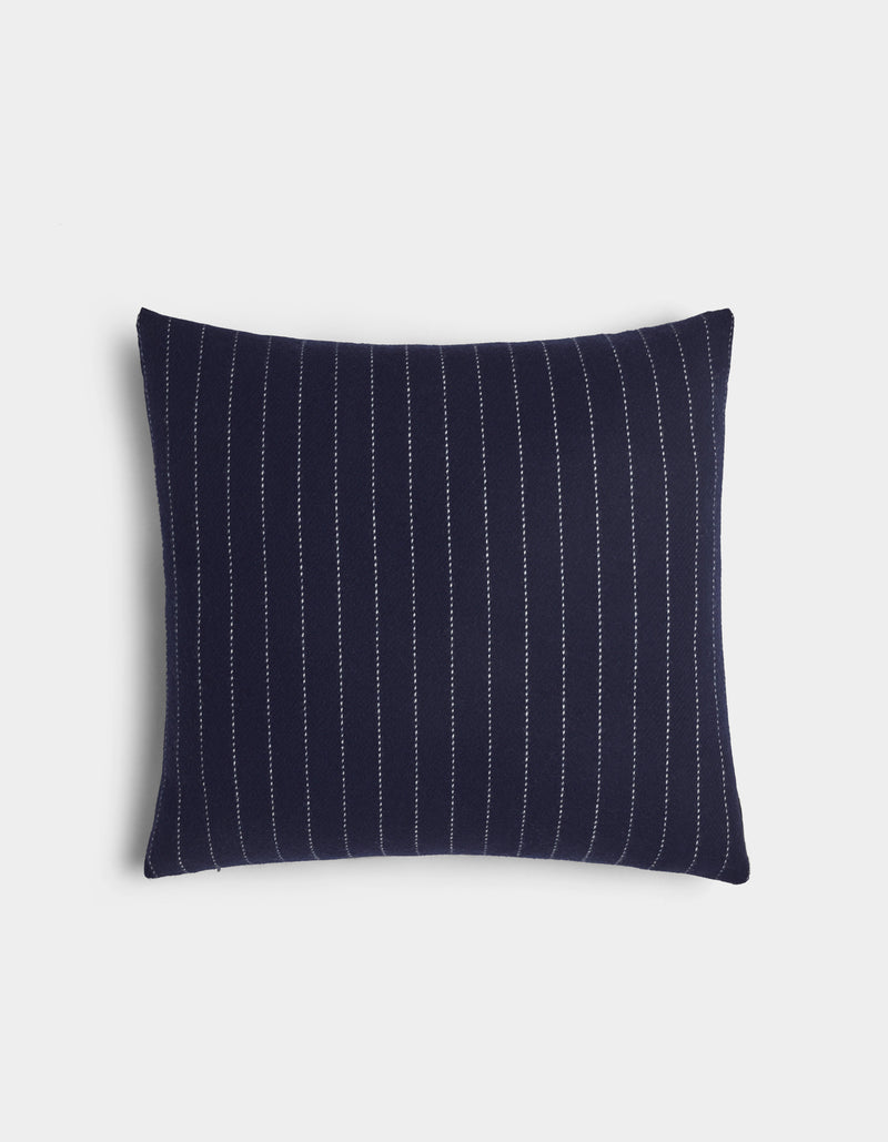 The Florence Pillow by Cozy Earth is a rectangular navy blue pillow with vertical white pinstripes, shown on a plain white background.