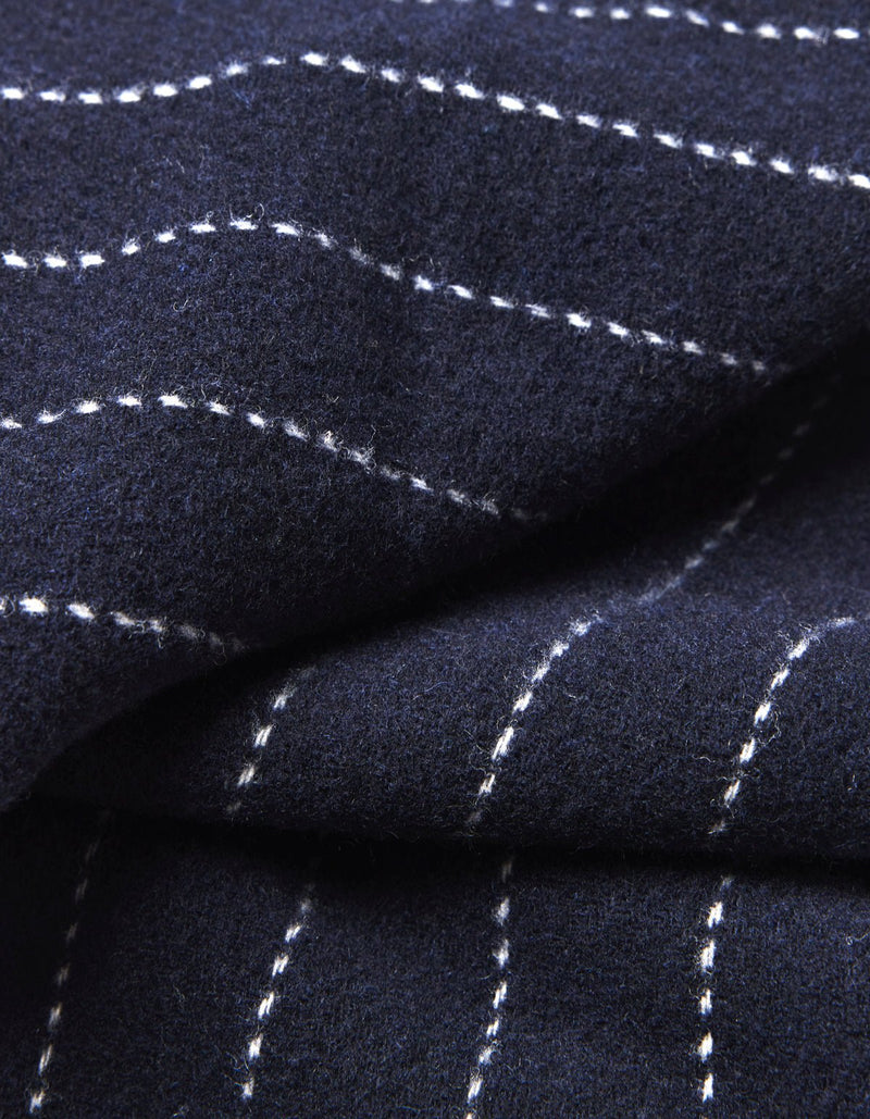 Close-up of Cozy Earth's Florence Throw in dark navy blue, featuring white dashed lines forming a subtle grid pattern. The soft fabric is shown slightly folded.