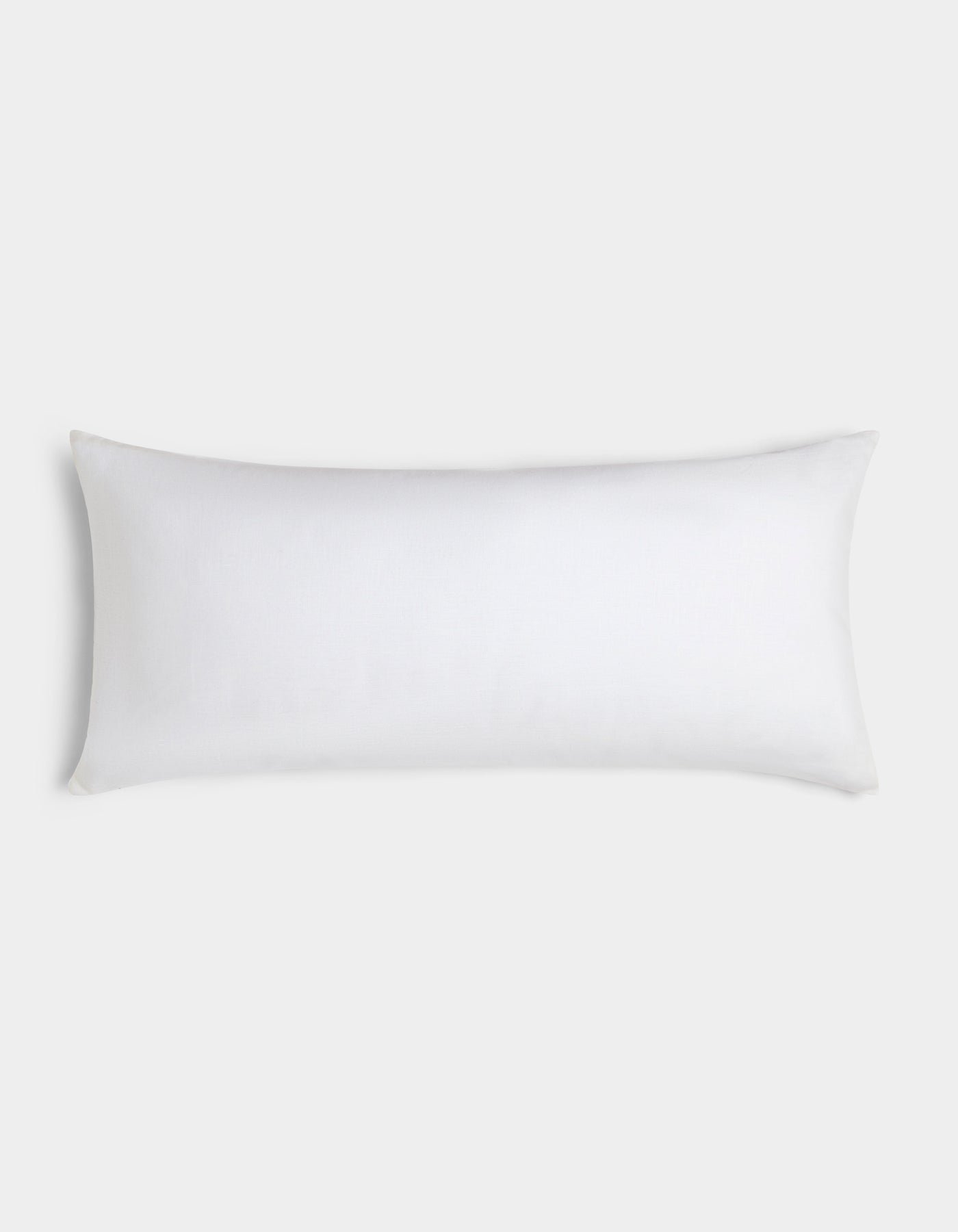 The Cozy Earth Linen Throw Pillow, featuring a simple white rectangular design, is displayed against a light gray background.