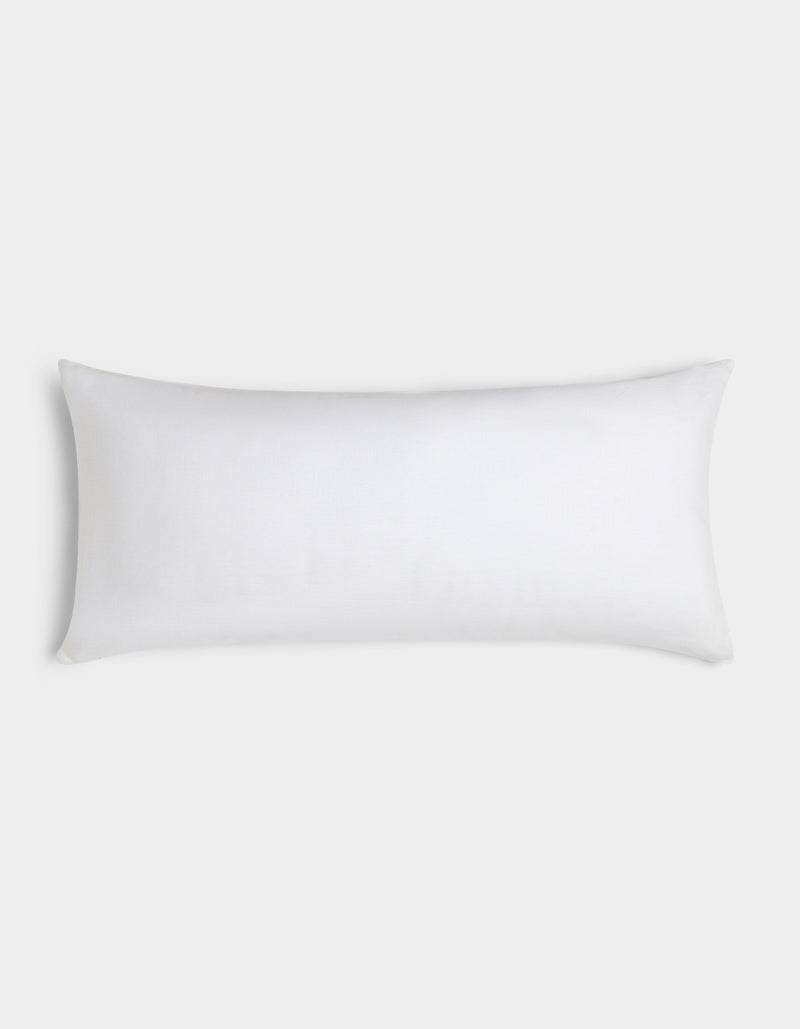 The Cozy Earth Linen Throw Pillow, featuring a simple white rectangular design, is displayed against a light gray background.