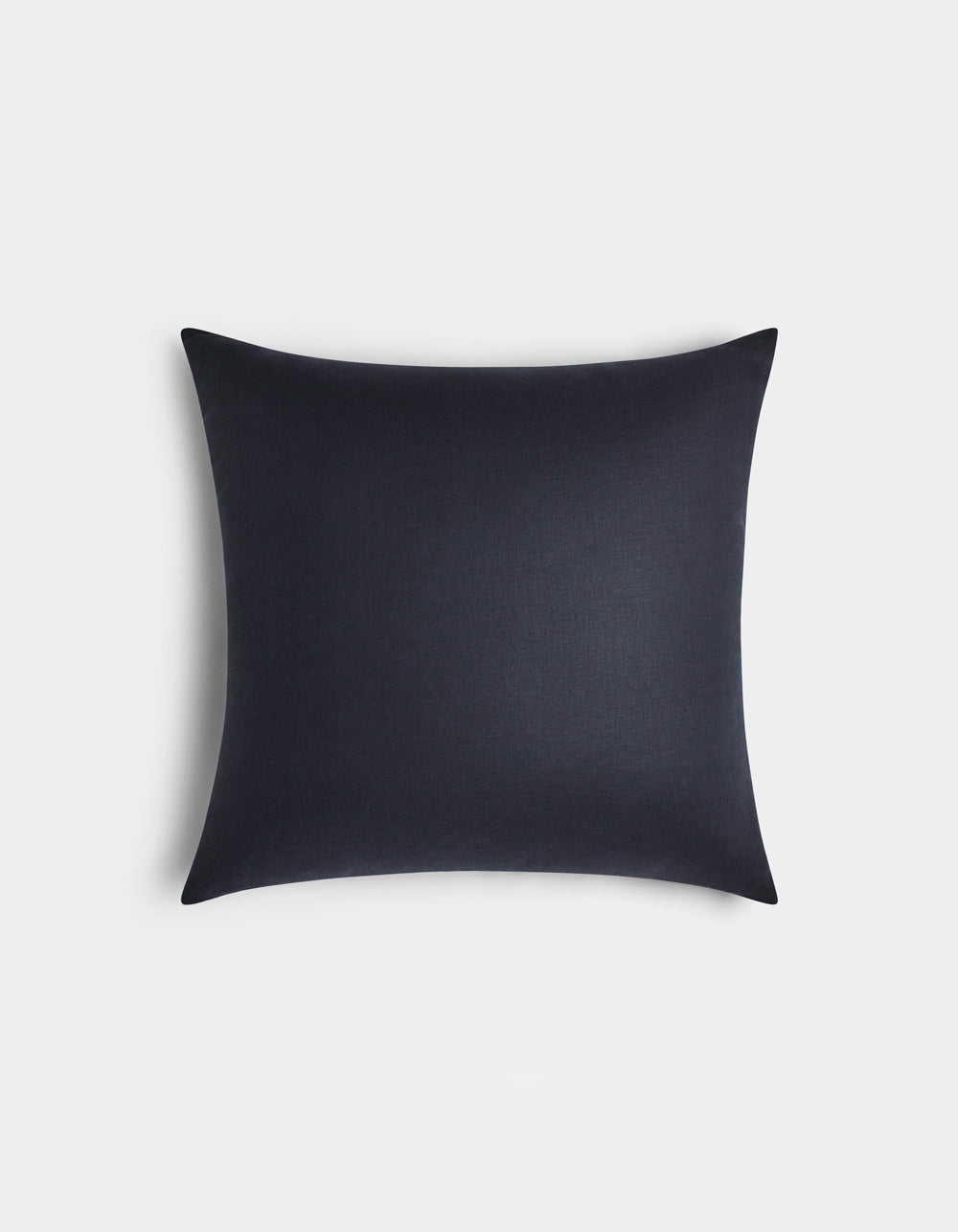 The Cozy Earth Linen Throw Pillow is square and dark navy blue with a smooth, plain fabric, displayed against a light gray background.