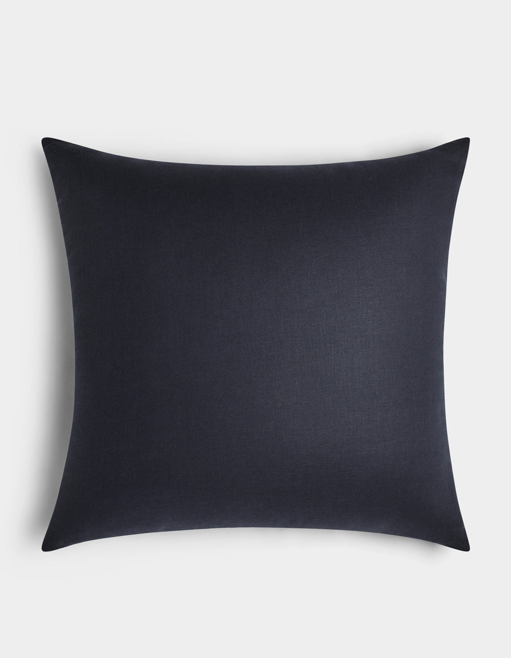 The Cozy Earth Linen Throw Pillow, featuring a smooth black surface and square shape, is placed centrally against a white background.