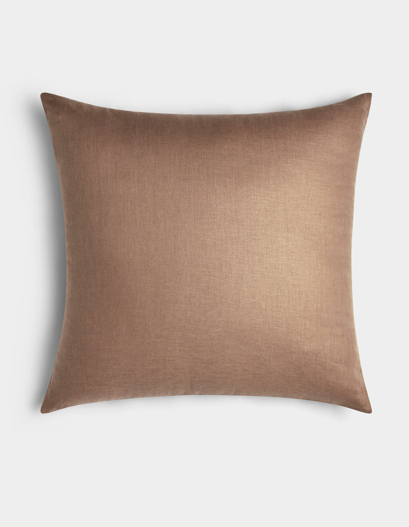 Cozy Earth’s Linen Throw Pillow features a smooth, plain brown cover and is pictured against a white background.