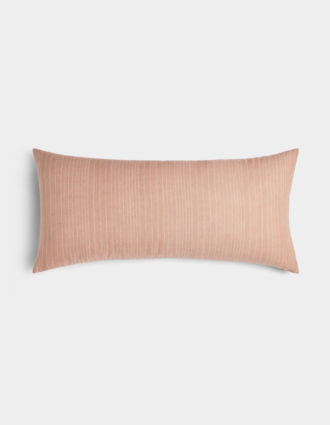 The Cozy Earth Striped Throw Pillow features a rectangular, blush pink design with subtle vertical white pinstripes, shown on a plain white background.