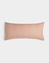 The Cozy Earth Striped Throw Pillow features a rectangular, blush pink design with subtle vertical white pinstripes, shown on a plain white background.|Color:Clay|Size:14" x 30"