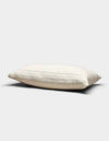 The Baja Matelasse Sham by Cozy Earth, in a cream shade with subtle horizontal stripes, rests on a plain light gray background. Its soft, gently flattened appearance suggests both comfort and support.|Color:Alabaster/Oceanside