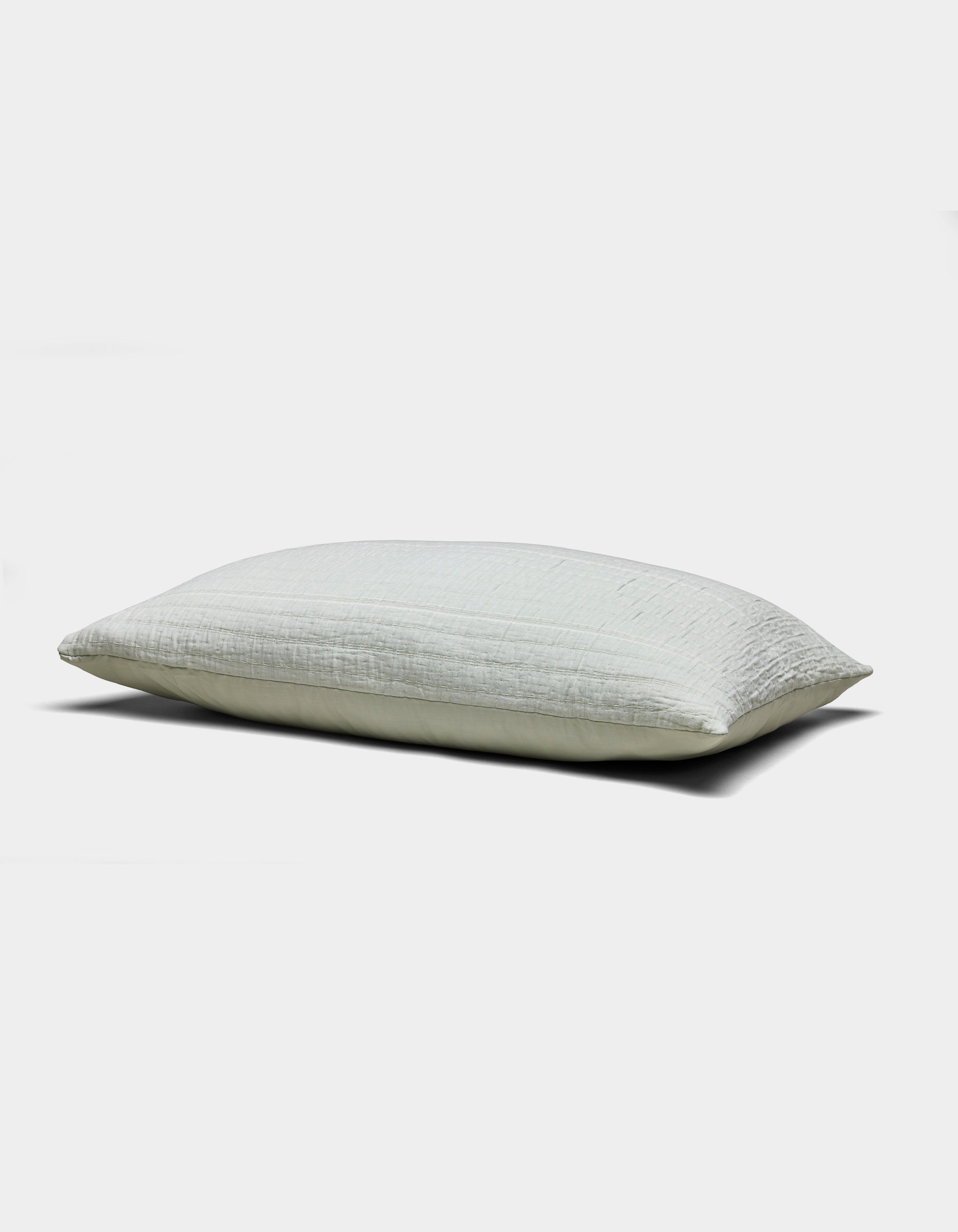 The Baja Matelasse Sham by Cozy Earth is a light-colored, rectangular pillow sham with a soft, textured surface. Displayed against a white background, it looks plush and comfortable.|Color:Bone/Laurel