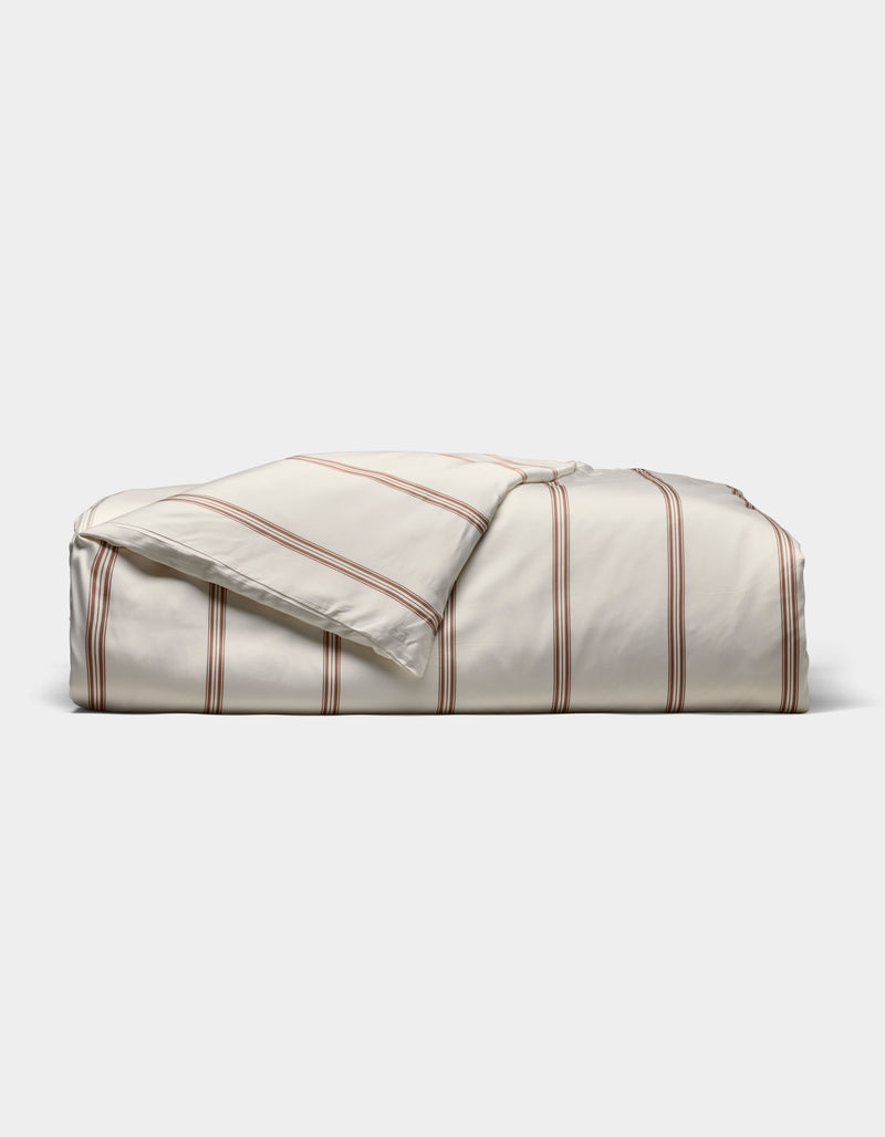 The Cozy Earth Bamboo Duvet Cover, in cream with thin red stripes, is shown neatly folded against a plain white background.