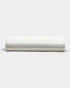 The Bamboo Sheet Set by Cozy Earth is shown neatly rolled, featuring subtle horizontal gray stripes near the edge, set against a plain light gray background.|Color:Baja Stripe in Laurel