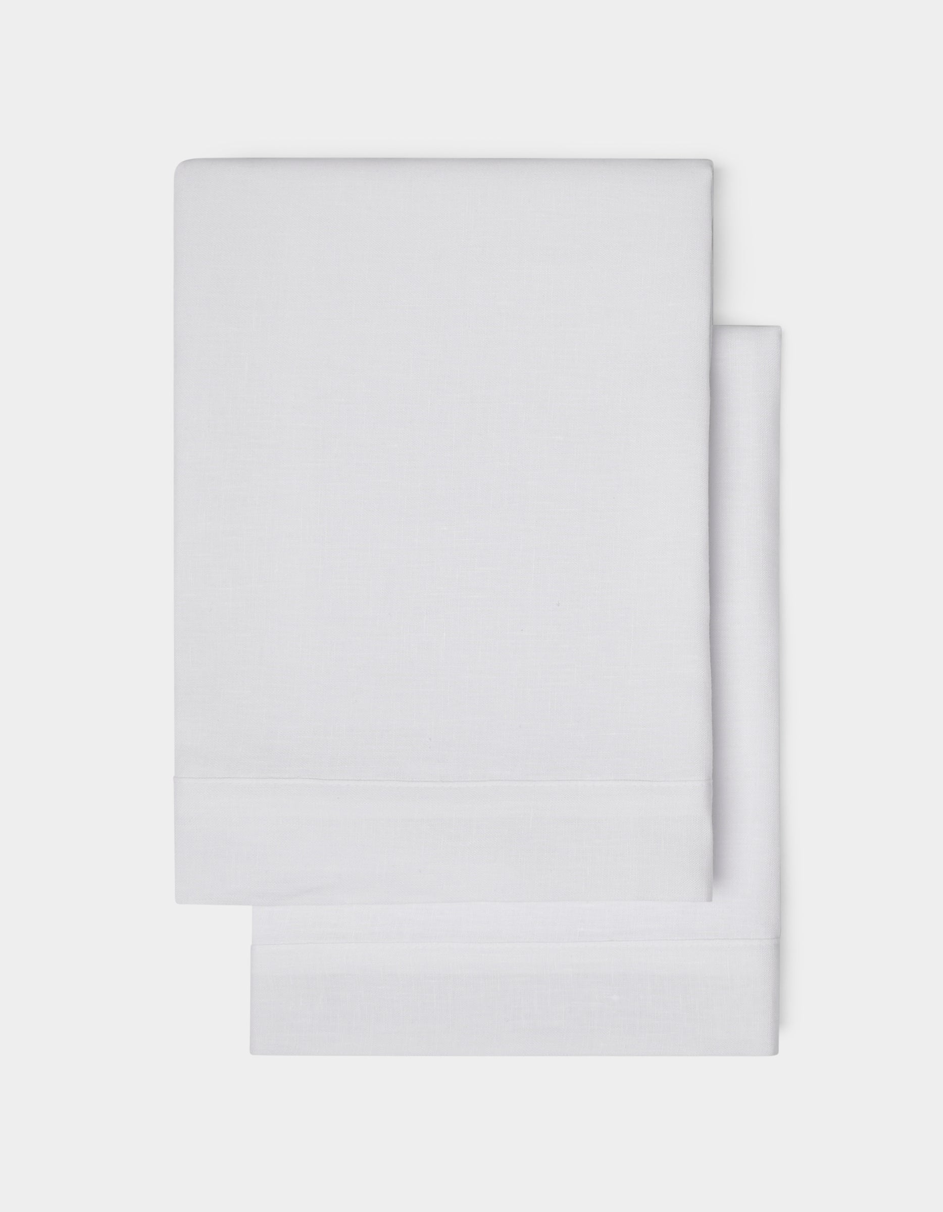 Cozy Earth Linen Shams, neatly folded in plain white with a simple hemmed edge, are shown on a white background.