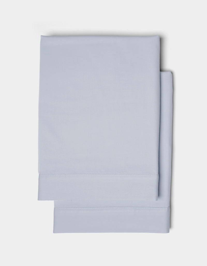Two neatly folded Cozy Earth Soft-Wash Cotton Shams in light blue are stacked together against a plain white background.