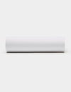 A Soft-Wash Cotton Fitted Sheet by Cozy Earth, in plain white, is displayed horizontally against a light gray background, viewed from the side.|Color:White