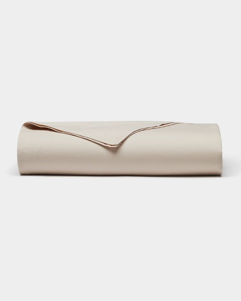 The Cozy Earth Soft-Wash Cotton Sheet Set is shown neatly folded in light beige on a plain white background.