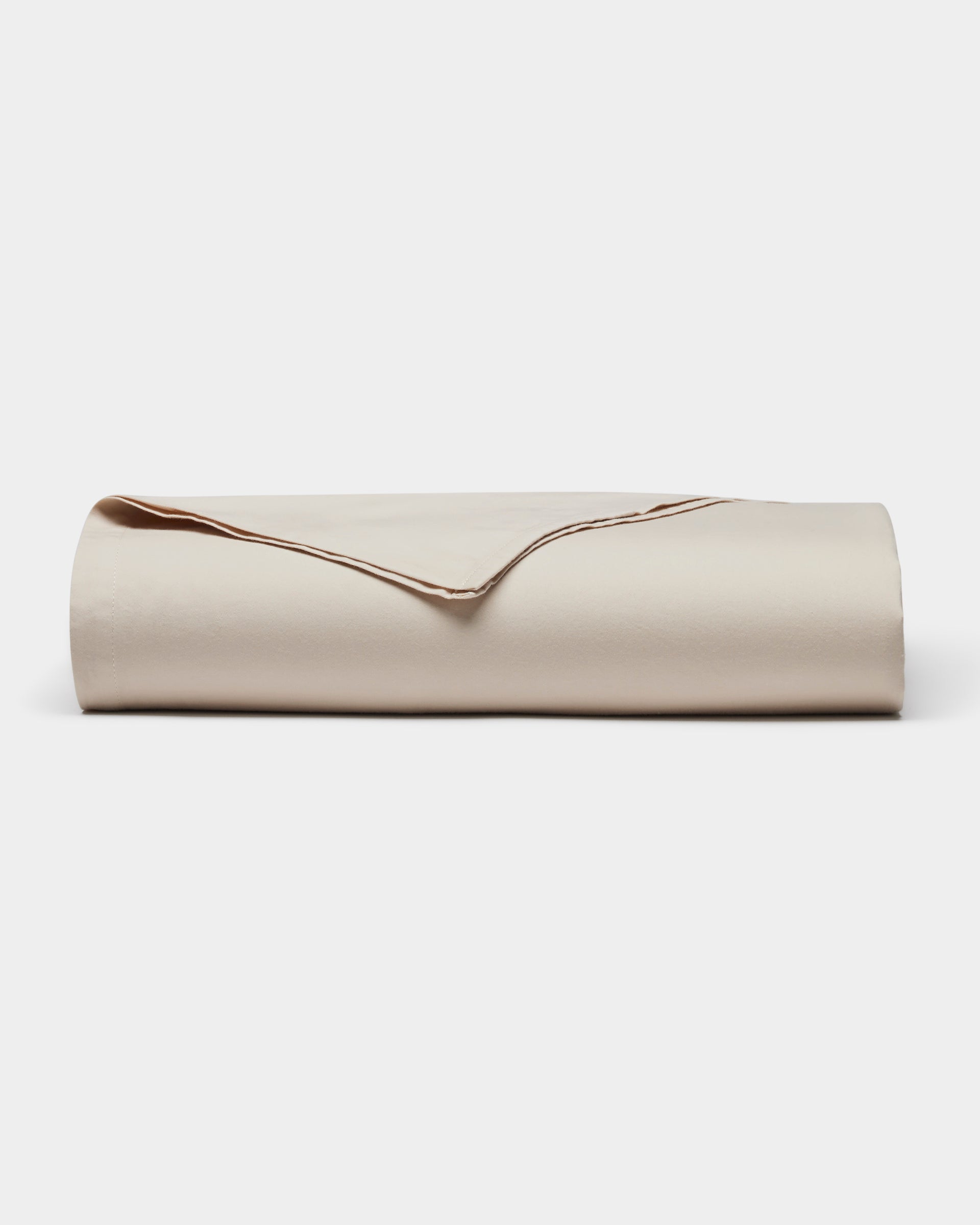 The Cozy Earth Soft-Wash Cotton Flat Sheet, neatly folded with one corner turned over to display its smooth texture and edges, is shown against a plain white background.