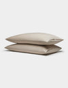 Two Soft-Wash Cotton Pillowcases by Cozy Earth are stacked together against a plain white background.|Color:Driftwood