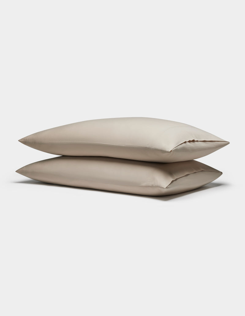 Two Soft-Wash Cotton Pillowcases by Cozy Earth are stacked together against a plain white background.
