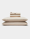 The Cozy Earth Soft-Wash Cotton Sheet Set is neatly folded with two stacked pillows at the bottom and matching sheets and pillowcases on top, all displayed against a plain white background.|Color:Driftwood