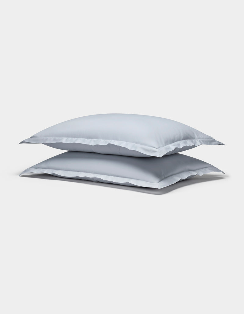 Two Cozy Earth Soft-Wash Cotton Shams in light gray are stacked neatly against a plain white background.
