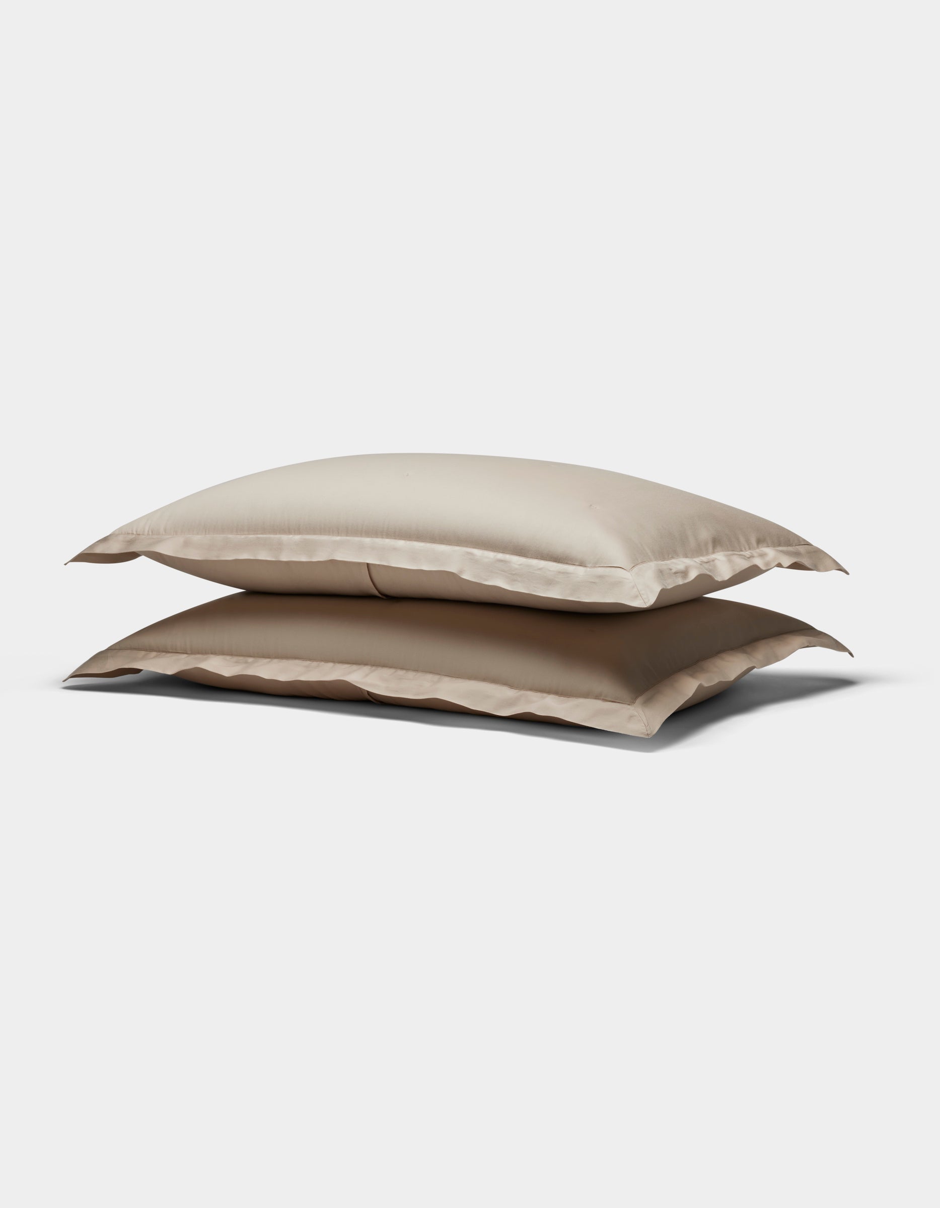 Two Soft-Wash Cotton Quilted Shams by Cozy Earth, in beige, stacked atop each other against a plain white background.|Color:Driftwood