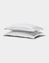 Two Cozy Earth Soft-Wash Cotton Quilted Shams, rectangular and white, are stacked atop each other against a plain white background.|Color:White