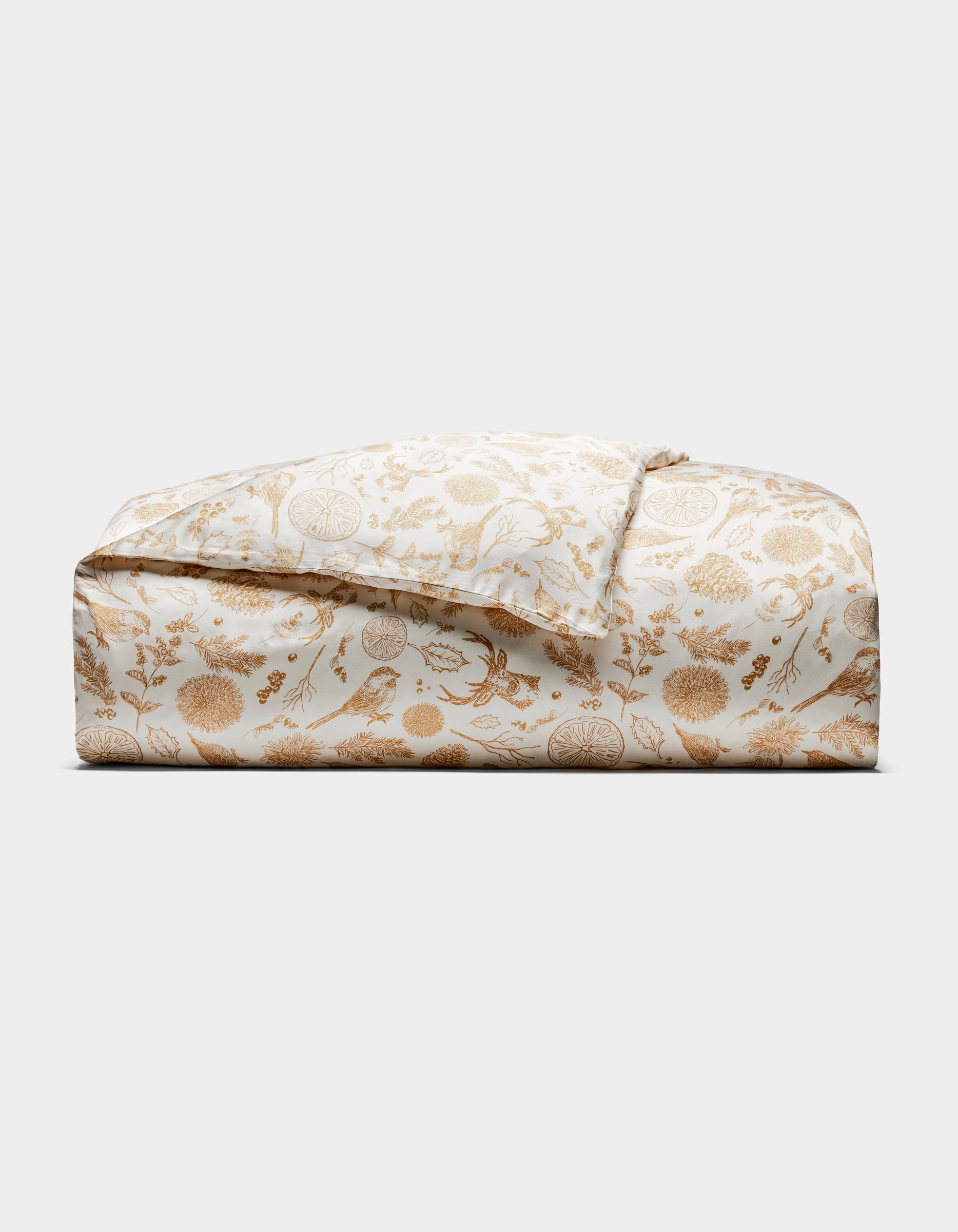 The Bamboo Duvet Cover by Cozy Earth is shown folded, featuring a white background with a gold floral and botanical print of detailed flowers, leaves, and birds, displayed against a plain white background.