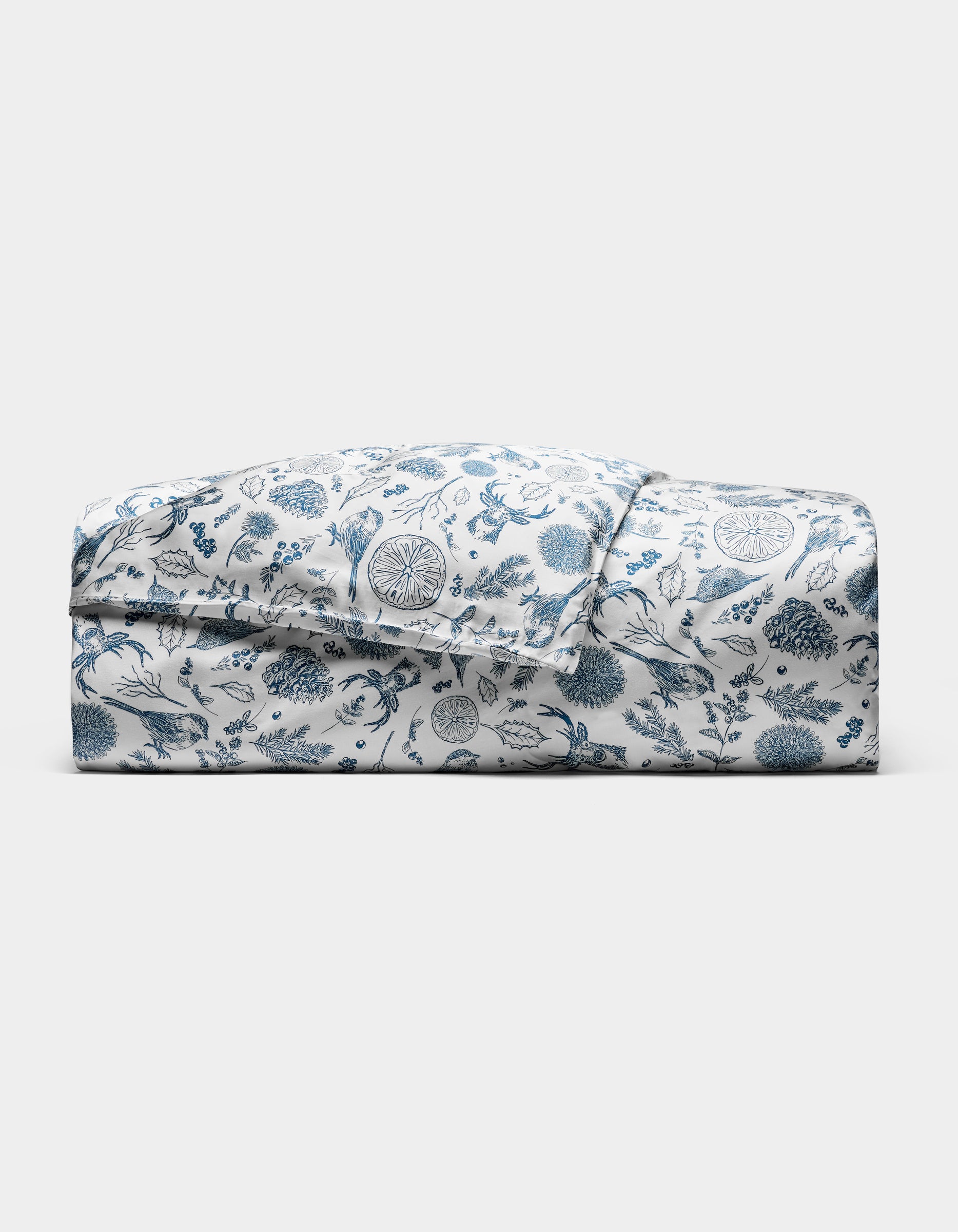 The Cozy Earth Bamboo Duvet Cover features a blue floral and botanical print on white, neatly folded and displayed against a plain white background.|Color:Winter Toile Pacific