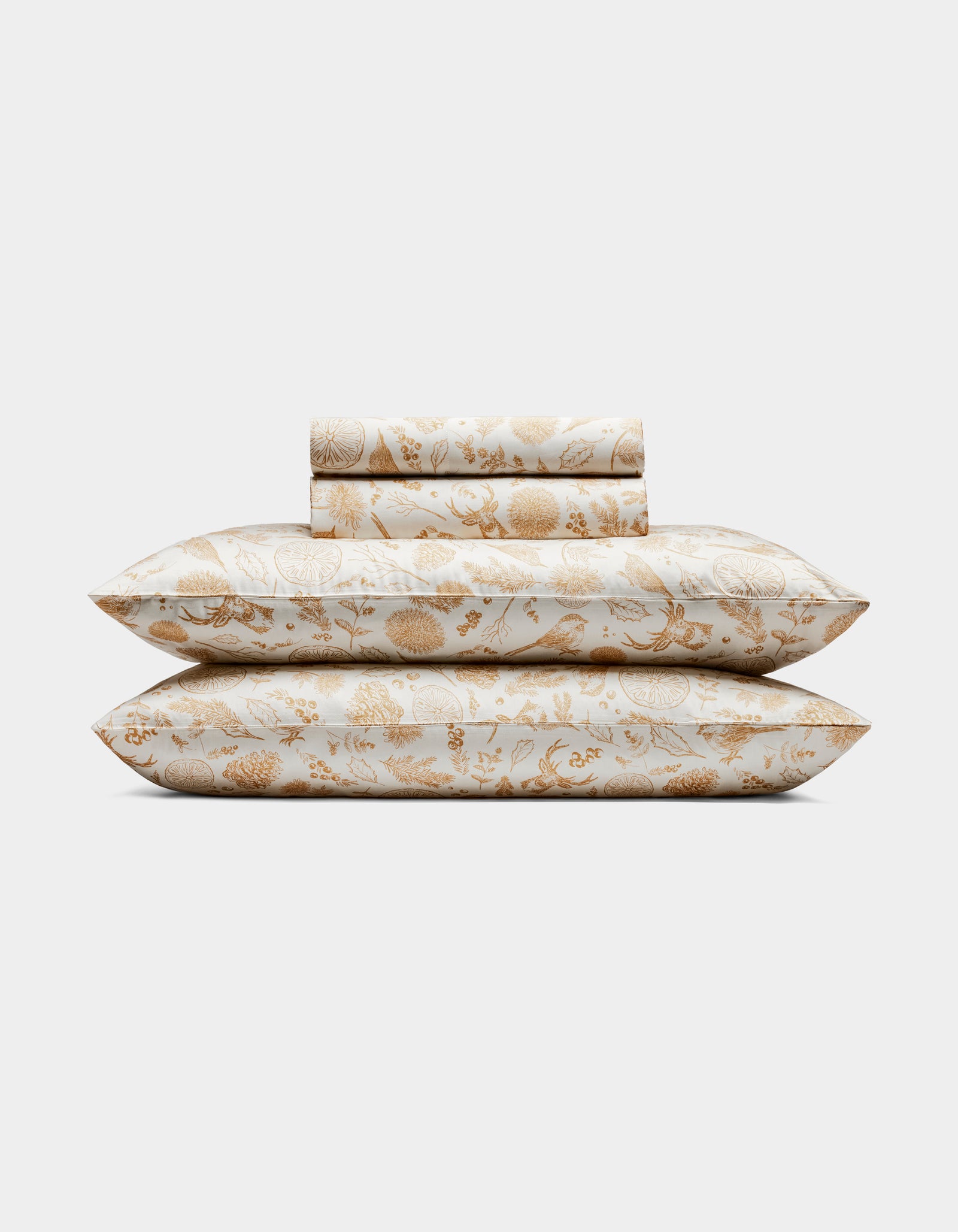 The Cozy Earth Bamboo Sheet Set includes two pillows and folded sheets with an intricate gold floral botanical pattern on a white background.