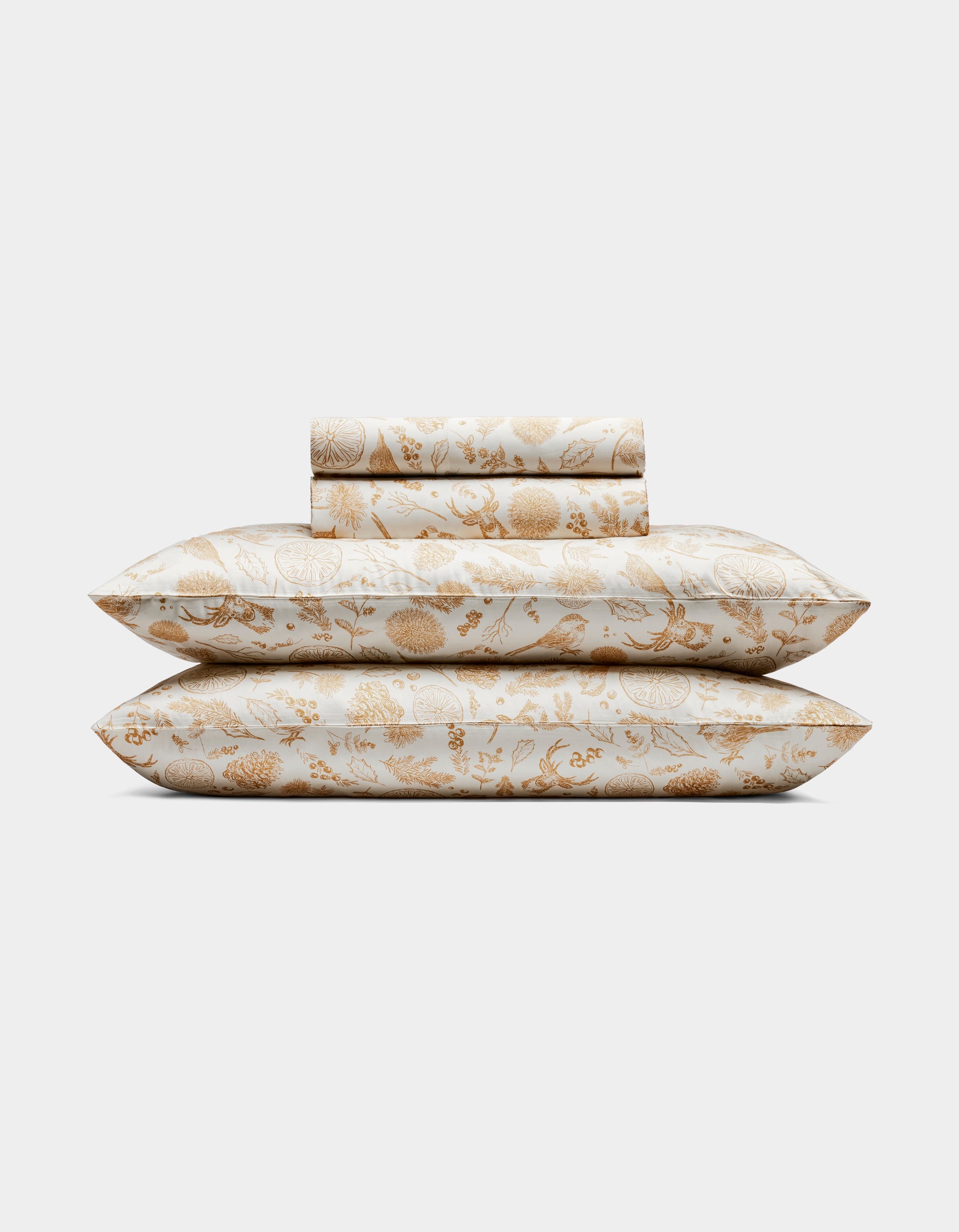 The Cozy Earth Bamboo Sheet Set includes two pillows and folded sheets with an intricate gold floral botanical pattern on a white background.