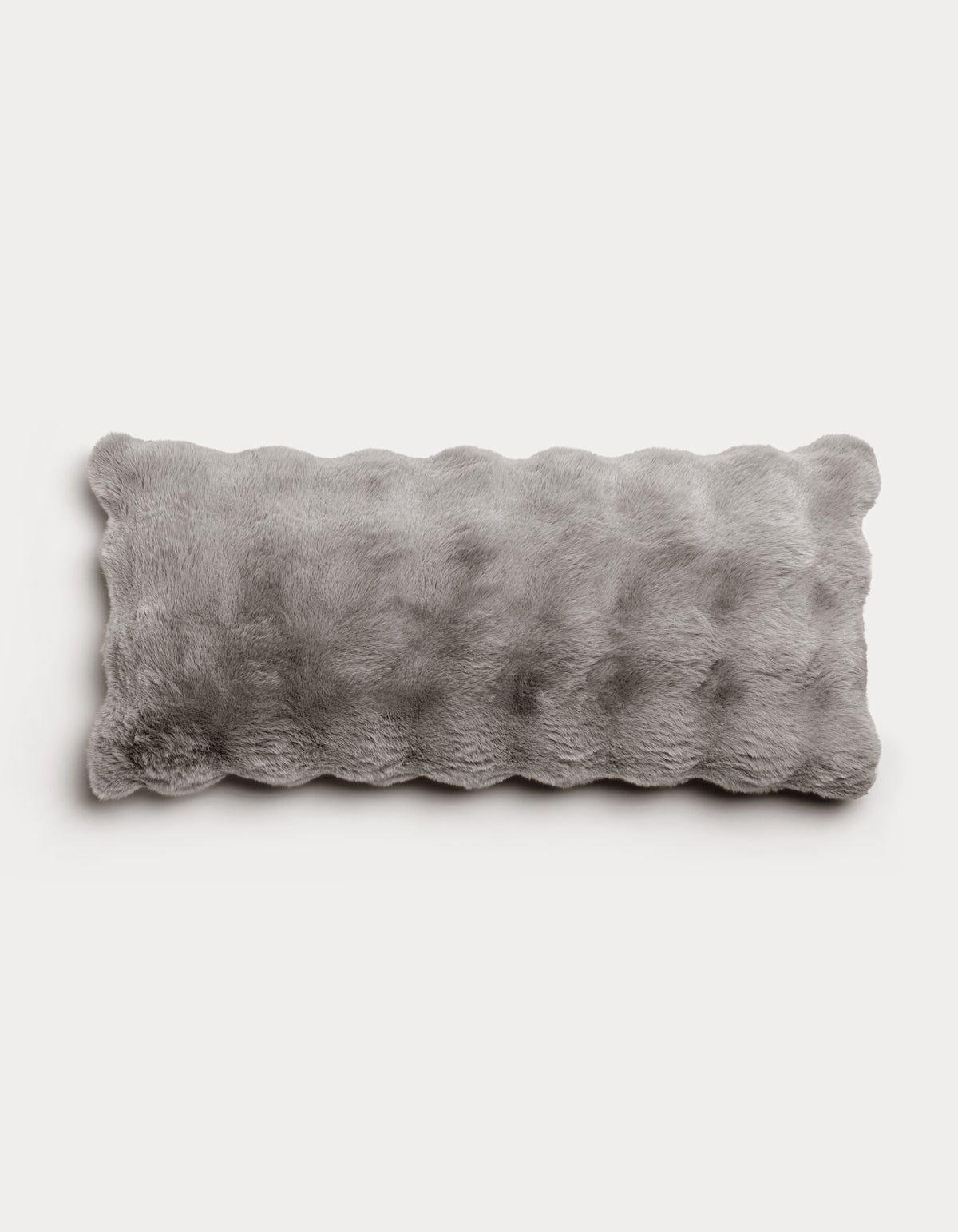 The Bubble Cuddle Pillow by Cozy Earth is a rectangular, fluffy white pillow with a soft, furry texture, displayed on a plain light gray background.|Color:Light Grey |Size:14" x 30"