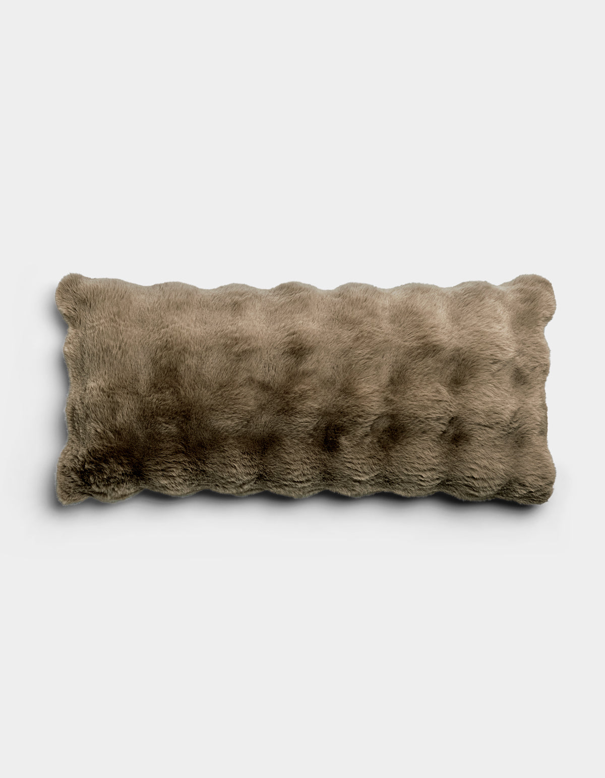 The Bubble Cuddle Pillow by Cozy Earth is a rectangular, light brown pillow with a soft, plush, furry texture, shown against a plain white background.