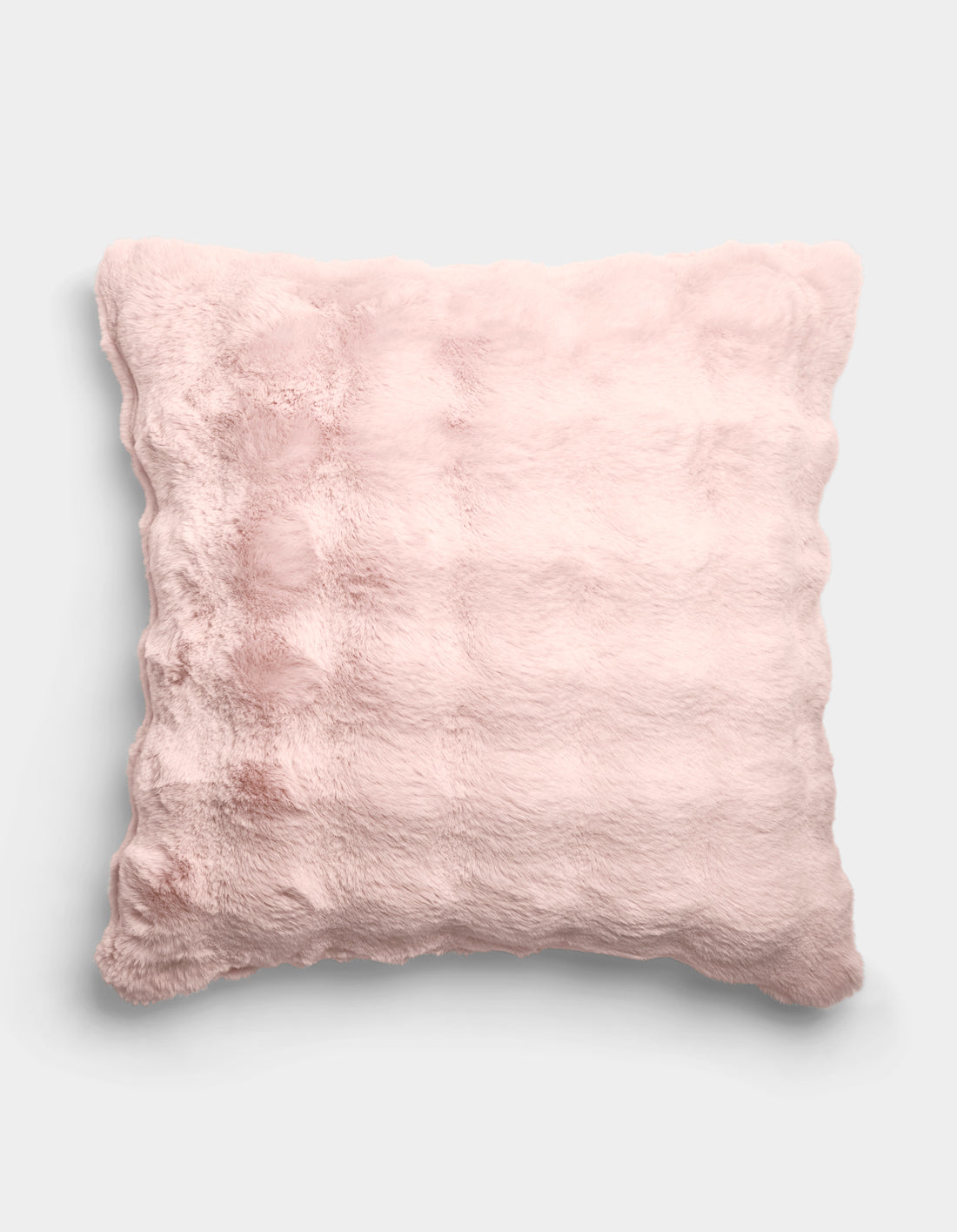 The Cozy Earth Bubble Cuddle Pillow, a square, light pink and fluffy cushion with a soft plush texture, is displayed against a plain white background.