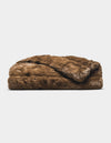 The Cozy Earth Channel Cuddle Blanket, a folded plush brown faux fur throw, is displayed against a plain white background.|Color:Cedar