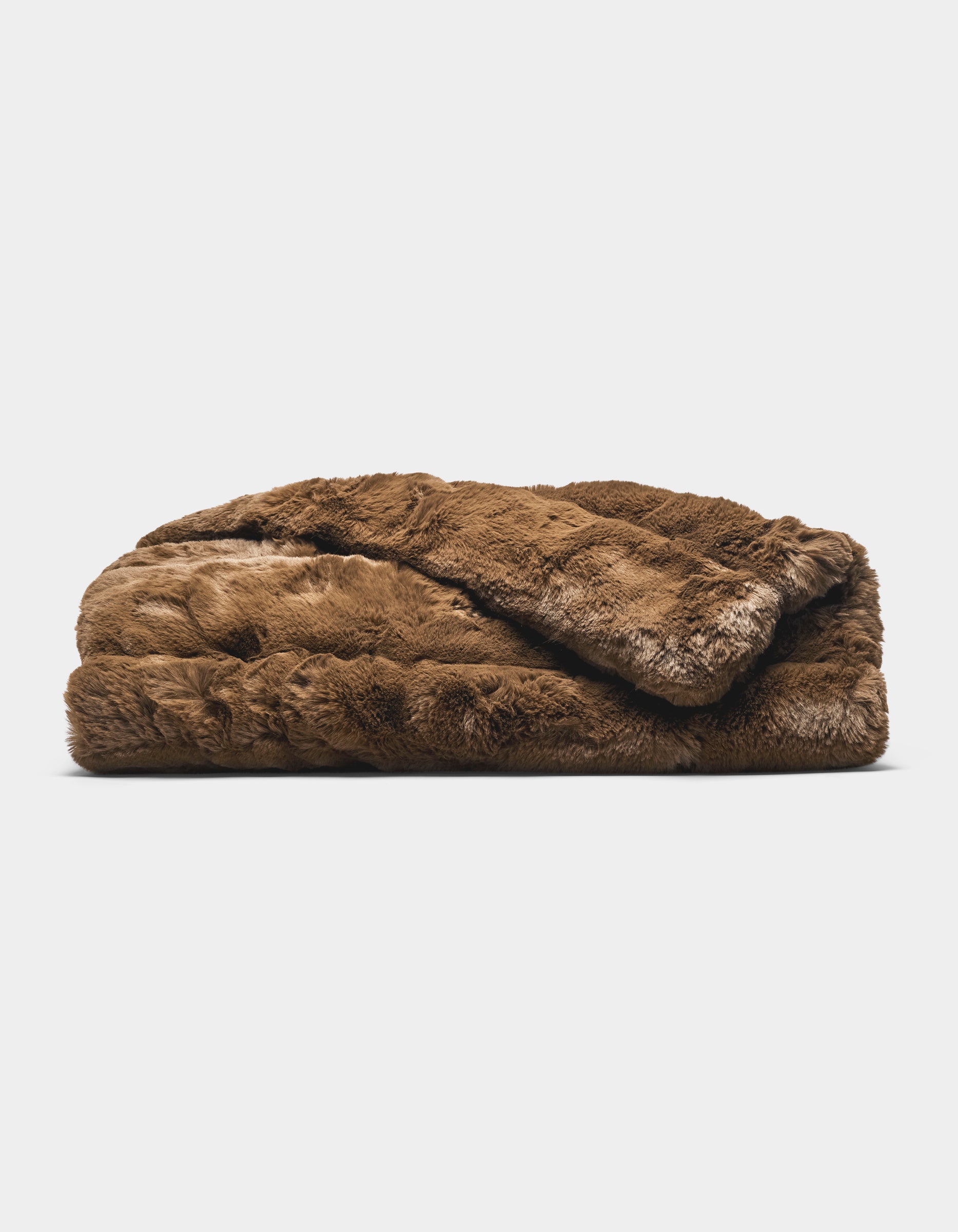 The Cozy Earth Channel Cuddle Blanket, a folded plush brown faux fur throw, is displayed against a plain white background.|Color:Cedar