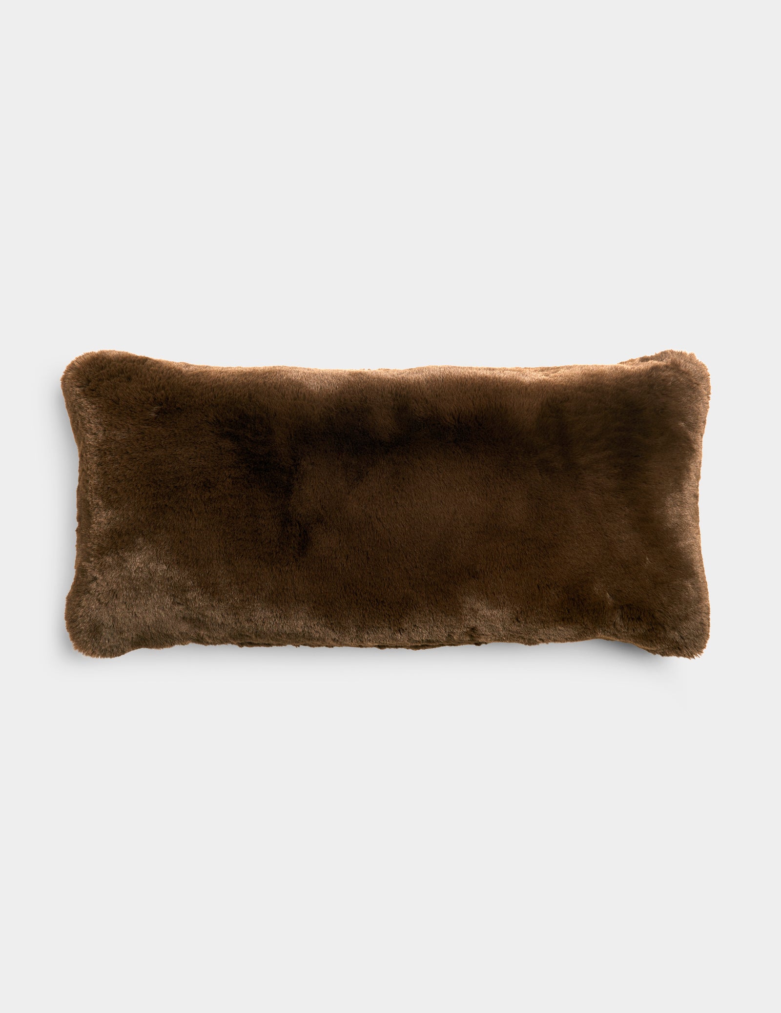 A Cozy Earth Cuddle Pillow in dark brown sits in front of a white background.